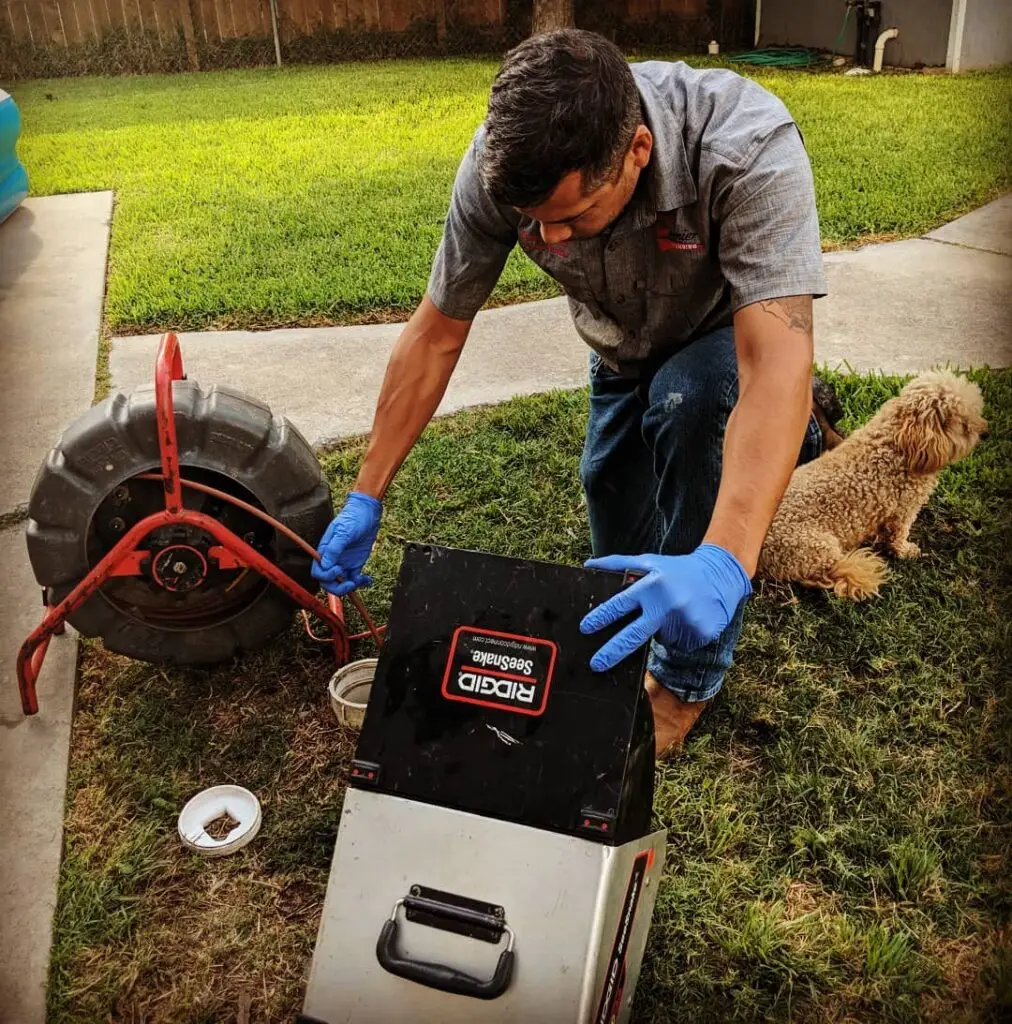 Premier Pros Plumbing & HVAC technician inspecting a drain line with a camera