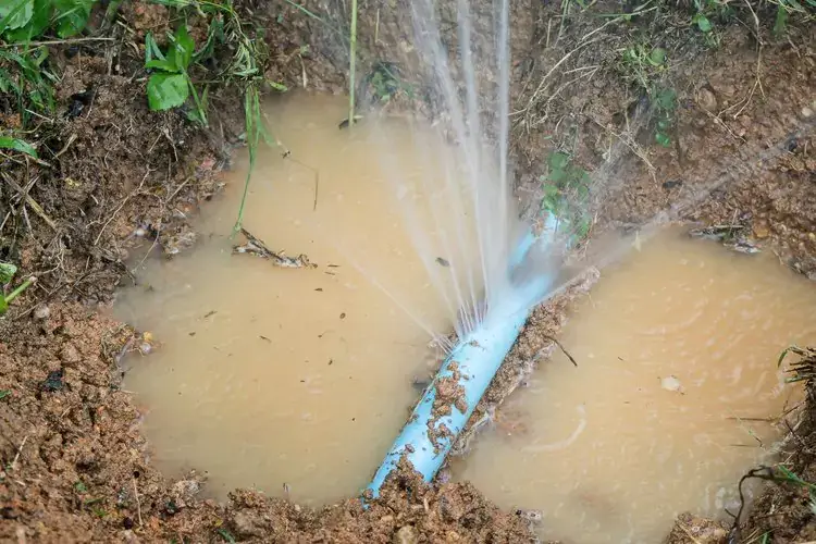 Burst water pipe with water spraying.