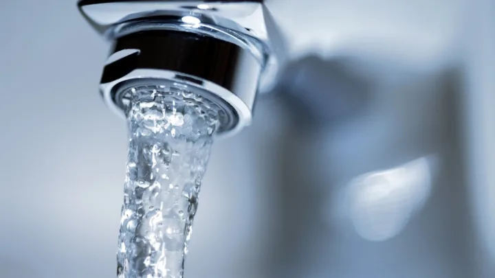 Person listening intently for the sound of running water when no taps are open in a San Antonio home